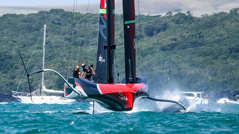 A couple of crew cross Emirates Team New Zealand just after a gybe - Training - Prada Cup Finals - Day 4 - February 21, 2021 - America's Cup 36 - Course A photo copyright Richard Gladwell / Sail-World.com / nz taken at Royal New Zealand Yacht Squadron and featuring the AC75 class