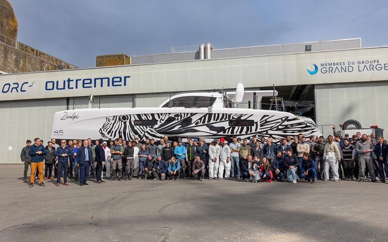Production teams proud of the first Outremer 45 built on the Lorient site photo copyright Julien Stintzy taken at  and featuring the Catamaran class