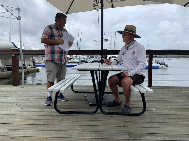 Peter Walsh race officer and QLD icon John Maclean in Kintsuji discussing pre race tactics on day 2 of the Australian International Contender Championships photo copyright Ross Hansen taken at Gosford Sailing Club and featuring the Contender class