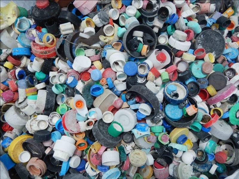 This photo, taken after a 21-day marine debris removal effort by the PIFSC, shows 4,781 bottle caps collected from Midway Atoll's shoreline. Most plastic bottle caps are made from polypropylene, also known as plastic #5, a hard, durable plastic - photo © NOAA Fisheries / PIFSC