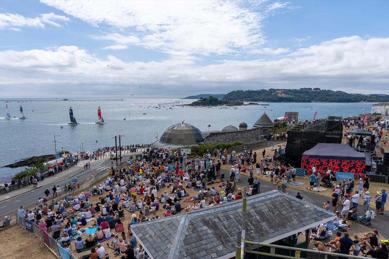 View of Canada SailGP Team helmed by Phil Robertson leading New Zealand SailGP Team co-helmed by Peter Burling and Blair Tuke from the Fan Village during Great Britain Sail Grand Prix | Plymouth photo copyright Ian Roman for SailGP taken at  and featuring the F50 class
