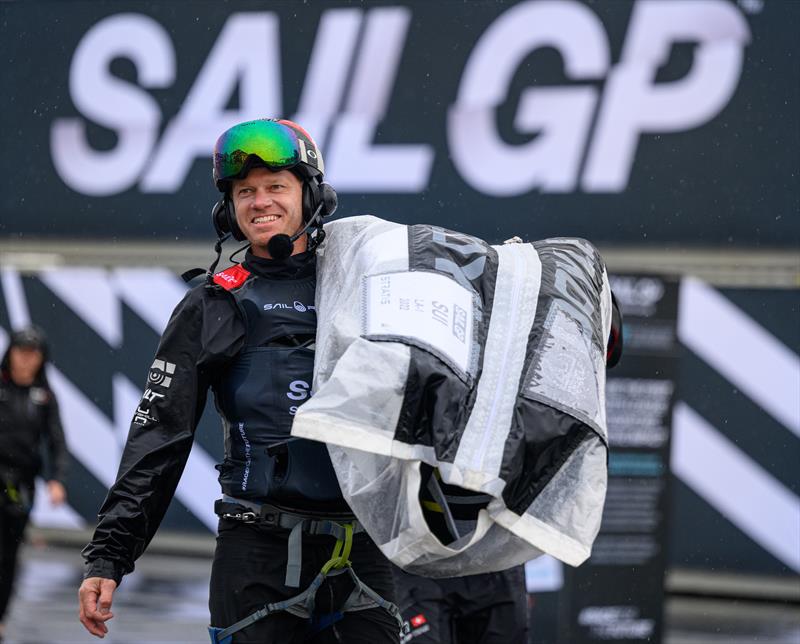 Nathan Outteridge, co-driver and sailing advisor of Switzerland SailGP Team, helps carry the team's Doyle Sails back across the Technical Base - SailGP Denmark photo copyright Jon Buckle/SailGP taken at Royal Danish Yacht Club and featuring the F50 class
