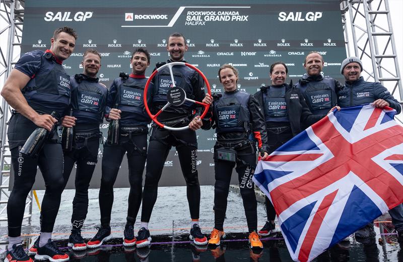 The Emirates Great Britain SailGP Team helmed by Giles Scott celebrate on stage with Barons De Rothschild Champagne and the winners trophy after winning the final race on Race Day 2 of the ROCKWOOL Canada Sail Grand Prix in Halifax, Canada © Felix Diemer for SailGP
