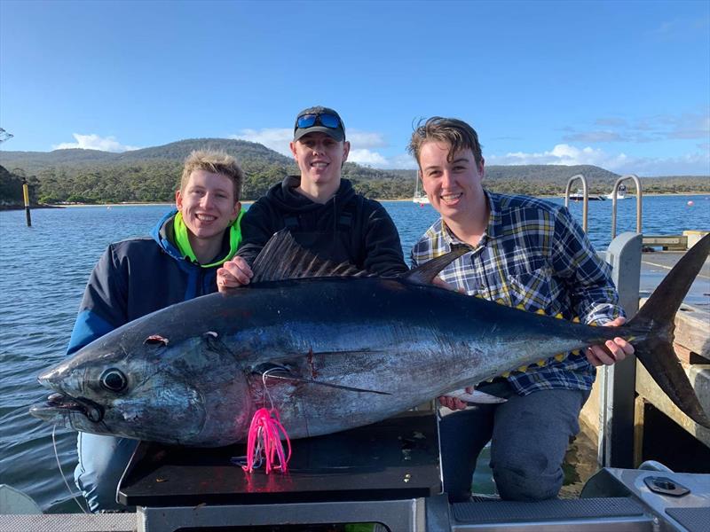 Spot On staff member Jonty (centre) with Max and Fraser and an 80kg Tuna caught out of the passage at Schouten Island on a Meridian Lure photo copyright Spot On Fishing Hobart taken at  and featuring the Fishing boat class