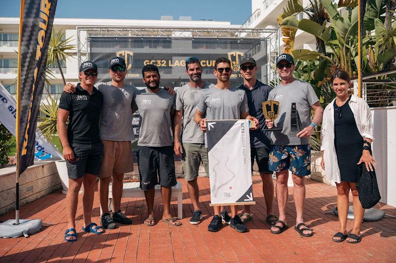 Simon Delzoppo and the crew of .film AUS Racing receive their prizes, including the owner-driver trophy at the GC32 Lagos Cup 2023 photo copyright GC32 Racing Tour / Tó Mané taken at  and featuring the GC32 class