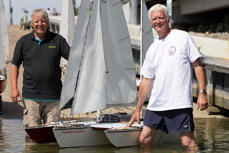 ARCHIVE, 2022 GGR RACE VILLAGE: Simon Crowhurst (Right), son of 1968 entrant Donald Crowhurst, and master model maker Bernard Mauviel (left) with the radio-controlled model of Teignmouth Electron. A really sepecial moment for everyone - photo © Tim Bishop / GGR / PPL
