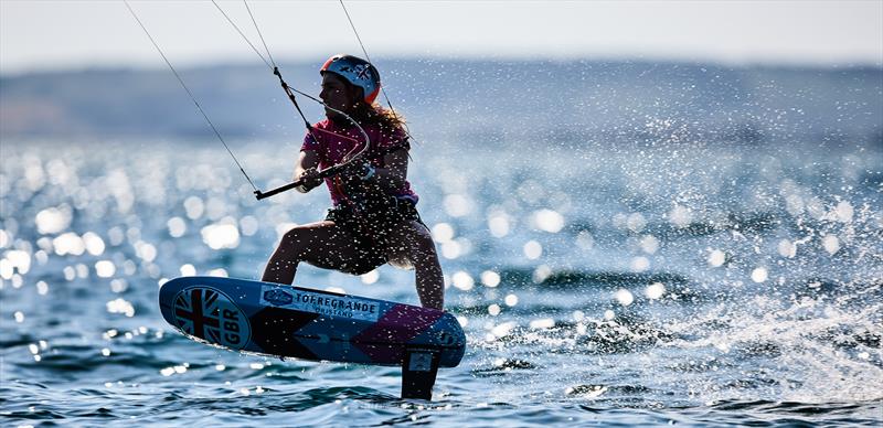 Francesca Maini (GBR) taking a break from exams on day 1 of the IKA Kitefoiling Youth Worlds Torregrande 2022 photo copyright Robert Hajduk / IKA media taken at  and featuring the Kiteboarding class