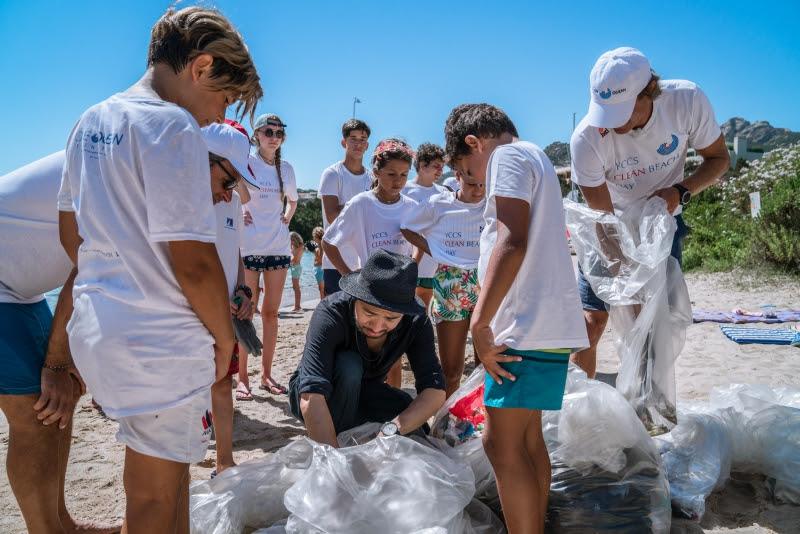 Jan Pachner, Secretary General of the YCCS and the MINIWIZ CEO Arthur Huang with the youths from the YCCS Sailing School during the beach cleaning photo copyright YCCS / Marcello Chiodino taken at Yacht Club Costa Smeralda