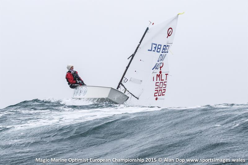 Belgium's Frédérique Van Eupen rides the crest of a wave at Pwllheli as racing is cancelled at the Magic Marine Optimist Europeans photo copyright Alan Dop / www.sportsimages.wales taken at Plas Heli Welsh National Sailing Academy and featuring the Optimist class