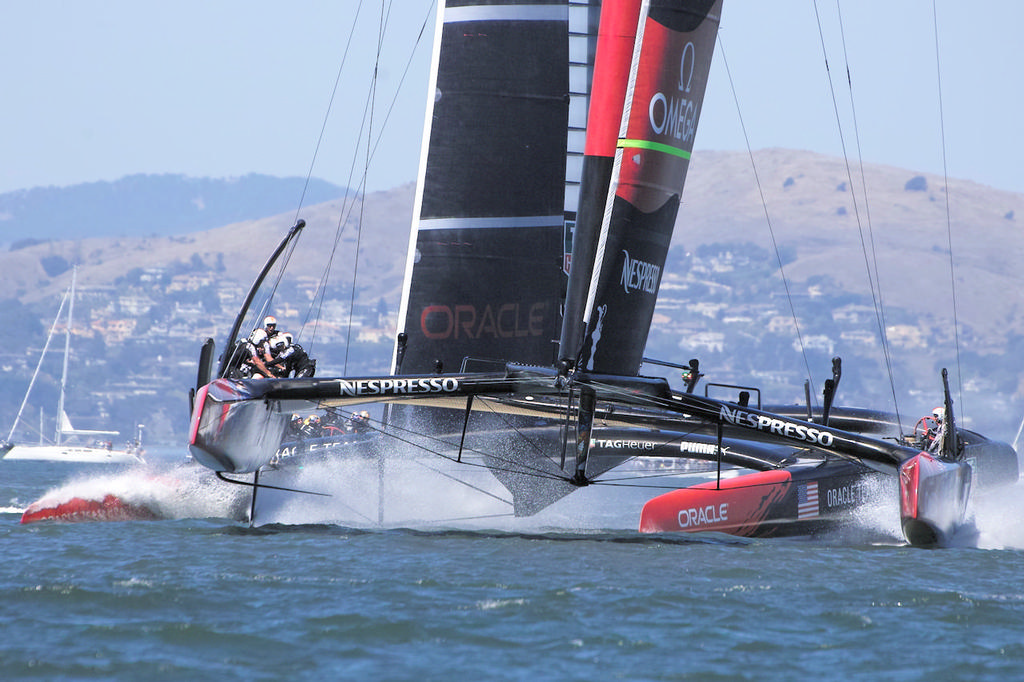 Emirates TNZ lifts onto their foils as Oracle takes a short nose dive before the first mark. - America's Cup photo copyright Chuck Lantz http://www.ChuckLantz.com taken at  and featuring the  class