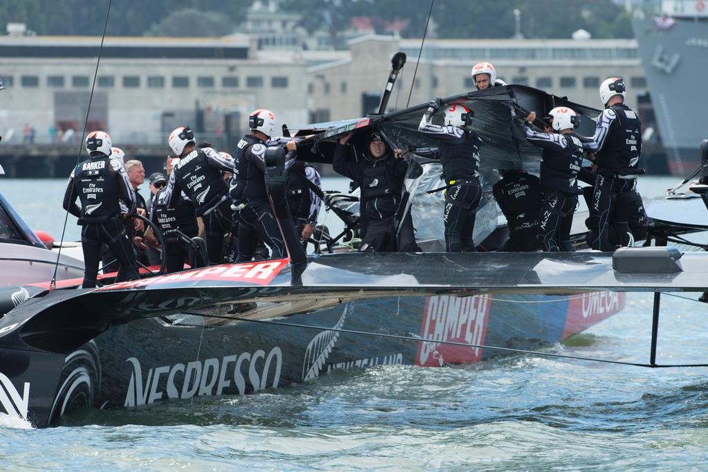 Emirates Team New Zealand remove the fairing broken at the top mark bear away in their first race of the Louis Vuitton finals against Luna Rossa Challenge. .17/8/2013 photo copyright Chris Cameron/ETNZ http://www.chriscameron.co.nz taken at  and featuring the  class