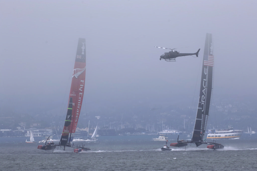 Emirates Team New Zealand and Oracle Team USA with chopper on watch - America’s Cup, day 2 © Chuck Lantz http://www.ChuckLantz.com