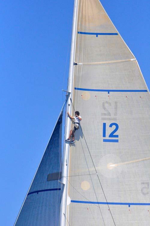 A sailor climbing the mast of one of the participating yachts during last year’s 12 Metre North Americans in Newport, R.I. © SallyAnne Santos