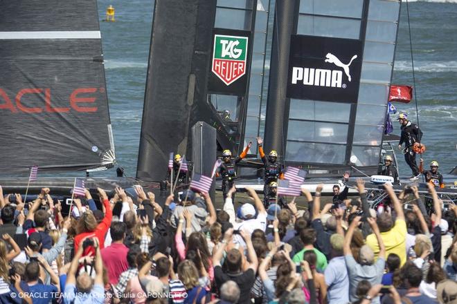 Crowd waving at the Oracle team USA at the 2013 34th America’s cup © Oracle team racing