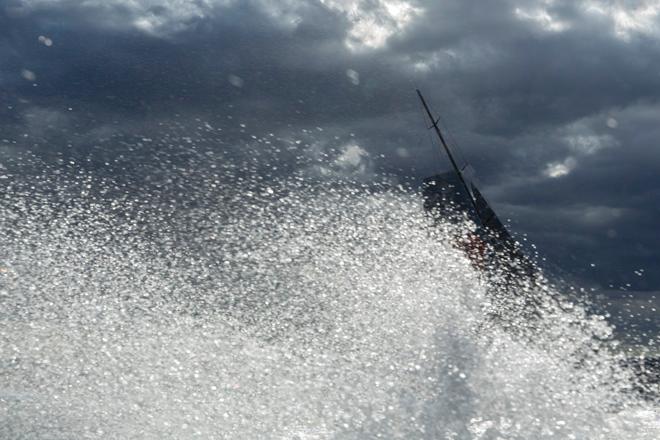 Wild Oats XI obscured by spray en route to winning Line honours in the 2013 Rolex Sydney to Hobart © Andrea Francolini
