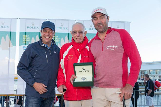 Owner Bob Oatley and skipper Mark Richards receive the trophy from Patrick Boutellier of Rolex Australia for winning Line honours in the 2013 Rolex Sydney to Hobart © Andrea Francolini