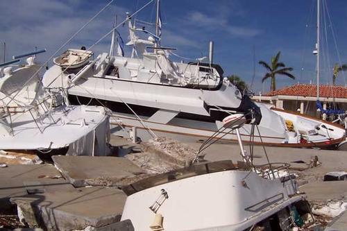 Photo of hurricane-damaged boats piled on top of each at a marina © onEdition http://www.onEdition.com