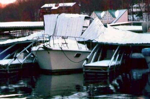 Photo of wind-damaged boats docked at a marina © onEdition http://www.onEdition.com