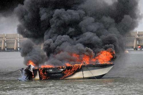 Photo of a powerboat on fire on the water © Christine Doyle