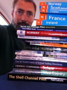 Paul Shard with stack of cruising guides for recent cruise around the UK and Brittany Coast of France photo copyright Sheryl Shard taken at  and featuring the  class