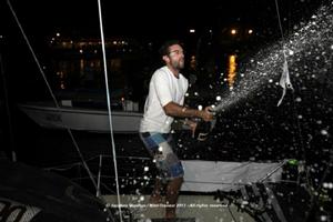 Benoit Marie sprays the victor&rsquo;s champaign as he arrives on the dock at the finish of the Mini Transat 2013 photo copyright  Jacques Vapillon / Mini Transat http://www.minitransat.fr taken at  and featuring the  class