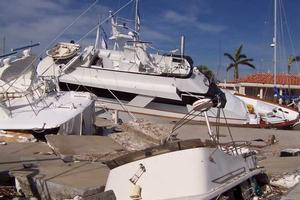 Photo of hurricane-damaged boats piled on top of each at a marina photo copyright onEdition http://www.onEdition.com taken at  and featuring the  class