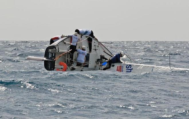  J/24 Island Water World Die Hard crew struggle to right the boat after a capsize in today’s windy race. - Mount Gay Round Barbados Race Series 2014 © Peter Marshall