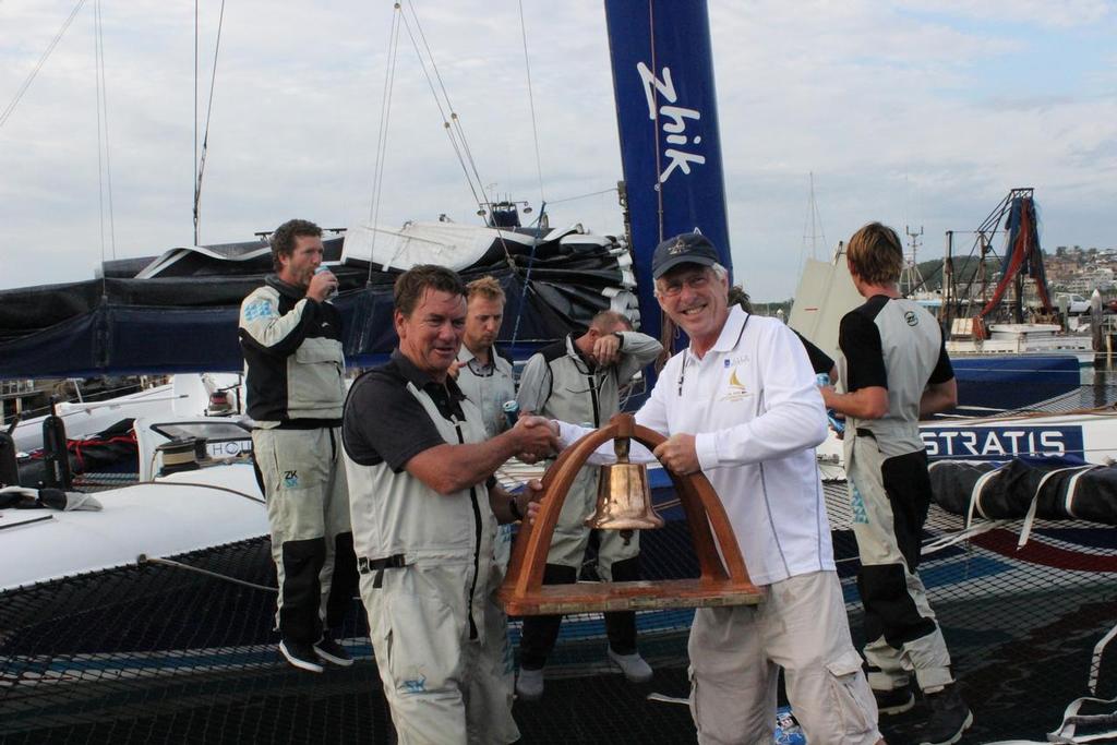 RPAYC Vice Commodore Ian Audsley, right, presents the line honours Bell trophy to Sean Langman dockside after the race. photo copyright Damian Devine taken at  and featuring the  class