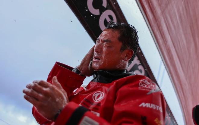 Leg Two, Day nine - Chen Jinhao (Horace) onboard  Chen Jinhao (Horace) taking advantage of the rain and having a quick head-wash  - Volvo Ocean Race 2014-15. © Yann Riou / Dongfeng Race Team