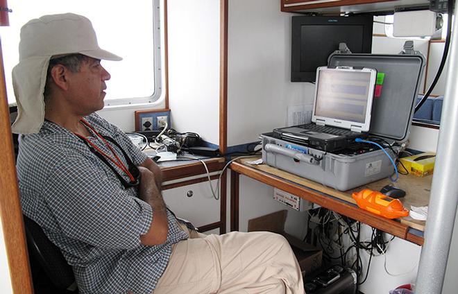 Aboard a boat in Massachusetts Bay, WHOI biologist Jesus Pineda keeps a steady vigil over his computer screen, waiting for evidence of an internal wave moving within the ocean depths. He is using a device called an echosounder, which uses sound waves to detect different densities of water masses.  © Leslie Baehr WHOI