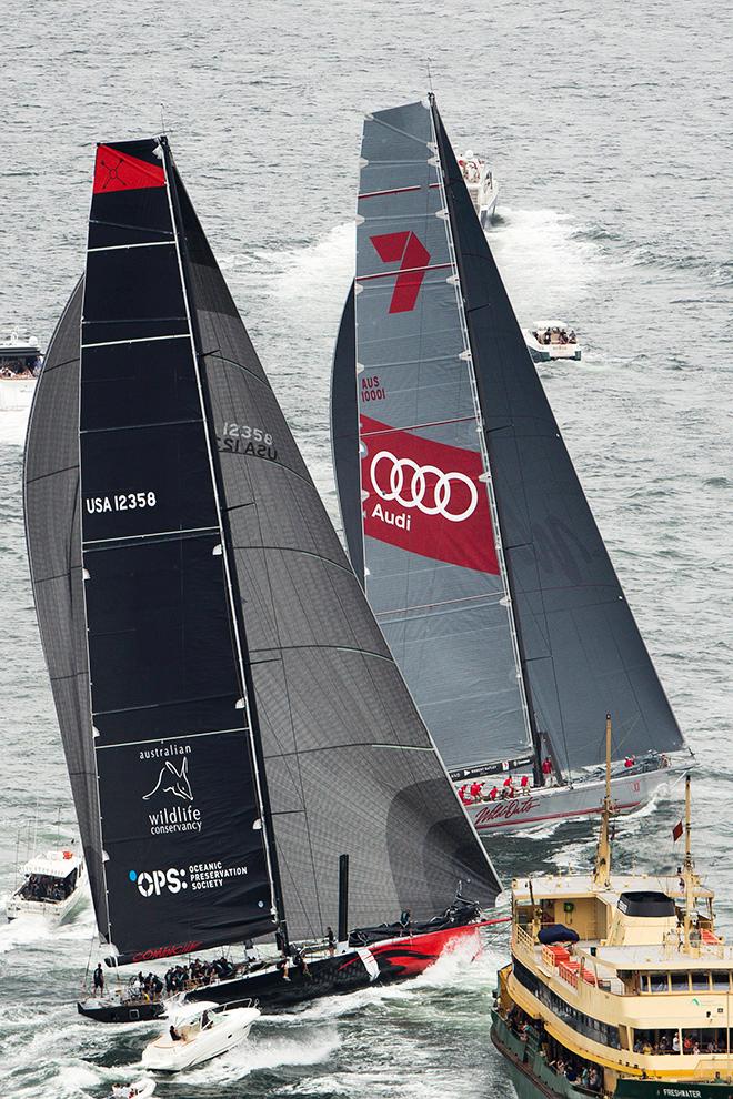 Streaking to victory: Bob Oatley’s supermaxi, Wild Oats XI, is escorted towards the finish line by a small armada of spectator boats during yesterday’s SOLAS Big Boat Challenge on Sydney Harbour. © Andrea Francolini http://www.afrancolini.com/