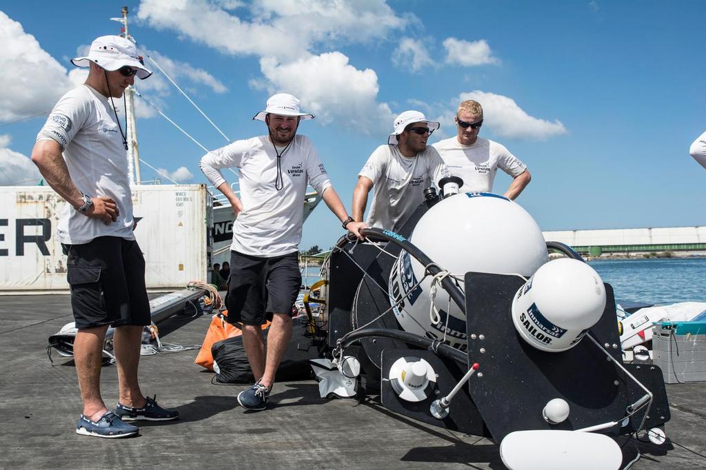 December 03, 2014. Team Vestas Wind crew arrives to Mauritius with all the equipment they rescued from the boat after grounding on the Cargados Carajos Shoals on the 29th November; The crew are safe and uninjured but had to abandon the ship after it sustained damage to the stern. Here the crew unloads all the equipment rescued from the boat.
 photo copyright  Marc Bow / Volvo Ocean Race taken at  and featuring the  class