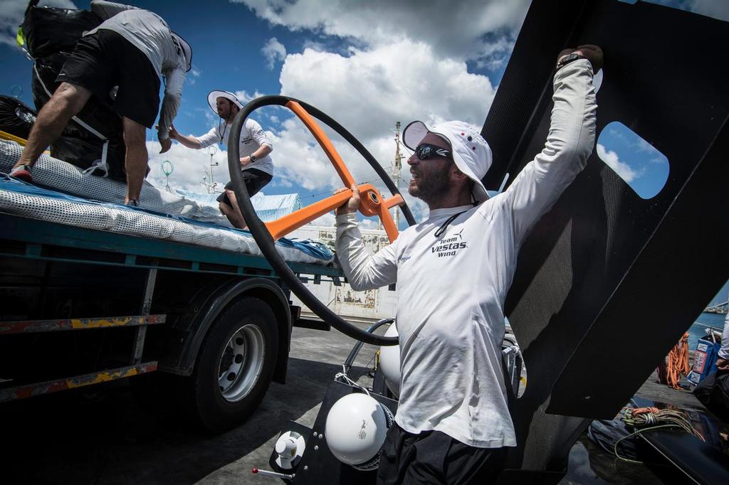 December 03, 2014. Team Vestas Wind crew arrives to Mauritius with all the equipment they rescued from the boat after grounding on the Cargados Carajos Shoals on the 29th November; The crew are safe and uninjured but had to abandon the ship after it sustained damage to the stern. In this image is Maciel Cicchetti ÒCichoÓ loading the helm and some pieces of the boat. photo copyright  Marc Bow / Volvo Ocean Race taken at  and featuring the  class