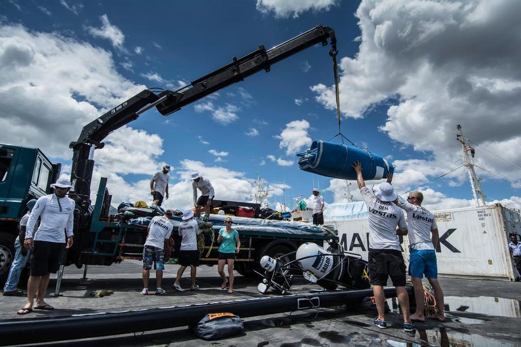December 03, 2014. Team Vestas Wind crew arrives to Mauritius with all the equipment they rescued from the boat after grounding on the Cargados Carajos Shoals on the 29th November; The crew are safe and uninjured but had to abandon the ship after it sustained damage to the stern. Here the crane loading the sails to a truck to transport all the recovered equipment from the boat. photo copyright  Marc Bow / Volvo Ocean Race taken at  and featuring the  class