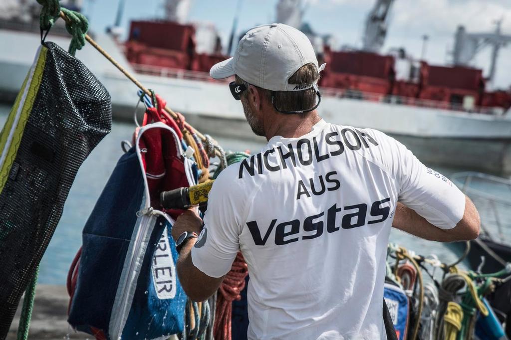 December 03, 2014. Team Vestas Wind crew arrives to Mauritius with all the equipment they rescued from the boat after grounding on the Cargados Carajos Shoals on the 29th November; The crew are safe and uninjured but had to abandon the ship after it sustained damage to the stern. In this image Chris Nicholson cleaning the equipment. photo copyright  Marc Bow / Volvo Ocean Race taken at  and featuring the  class