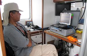 Aboard a boat in Massachusetts Bay, WHOI biologist Jesus Pineda keeps a steady vigil over his computer screen, waiting for evidence of an internal wave moving within the ocean depths. He is using a device called an echosounder, which uses sound waves to detect different densities of water masses. photo copyright Leslie Baehr WHOI taken at  and featuring the  class