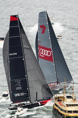 Streaking to victory: Bob Oatley’s supermaxi, Wild Oats XI, is escorted towards the finish line by a small armada of spectator boats during yesterday’s SOLAS Big Boat Challenge on Sydney Harbour. photo copyright Andrea Francolini http://www.afrancolini.com/ taken at  and featuring the  class