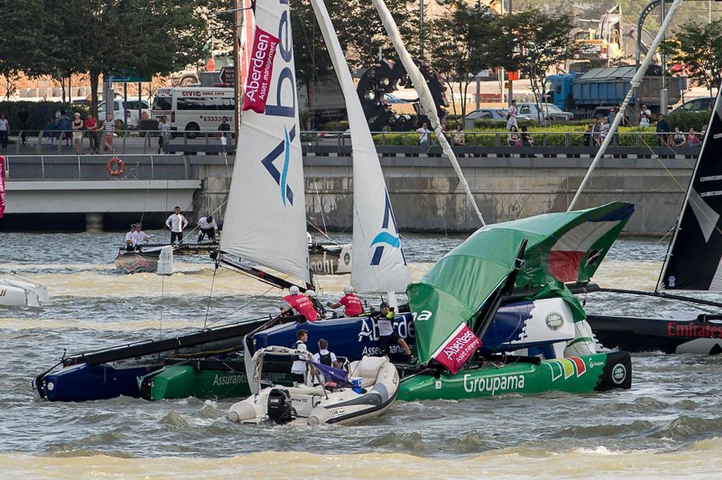 Team Aberdeen Singapore crashes down onto Groupama taking down the rig and injuring sailor Tanguy Cariou. Day three of the Extreme Sailing Series regatta being sailed in Singapore. 22/2/2014 photo copyright Chris Cameron/ETNZ http://www.chriscameron.co.nz taken at  and featuring the  class