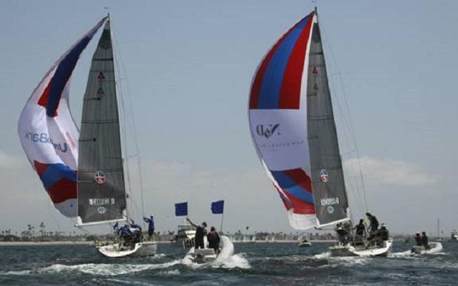 Taylor Canfield (l.) races downwind burdened by two penalty flags - Congressional Cup 2014 © Rich Roberts