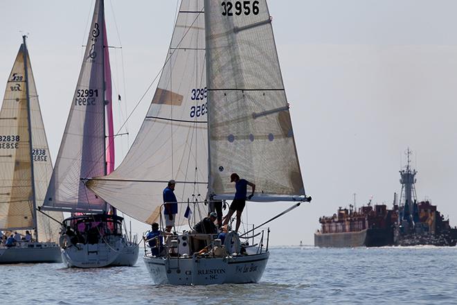 Ken King’s Sabre 38 Quintette (far left) fights through a calm spot to lead a group of three Pursuit Class boats out the jetties during Sperry Top-Sider Charleston Race Week 2014. © Meredith Block/ Charleston Race Week http://www.charlestonraceweek.com/