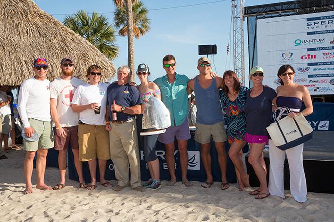 Overall winner of the Pursuit Spinnaker Class, Bill Hankle’s (blue shirt) Emocean crew from Wadmalaw Island, SC accepts their trophy at the Sperry Top-Sider Charleston Race Week 2014 awards ceremony. © Karen Ryan
