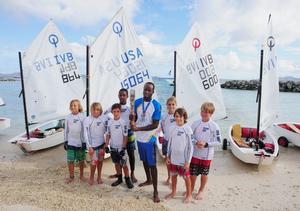 Thad Lettsome (left side of baton); Glenford Gordon (holding baton) and local optimist sailors with the Queen's Baton  - BVI Spring Regatta and Sailing Festival 2014 photo copyright Todd VanSickle / BVI Spring Regatta http://www.bvispringregatta.org taken at  and featuring the  class