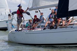 Family and friends make the most of the summer-like temperatures as cruising yachts from the Pursuit Class sail through the jetties.  - Sperry Top-Sider Charleston Race Week 2014 photo copyright Meredith Block/ Charleston Race Week http://www.charlestonraceweek.com/ taken at  and featuring the  class