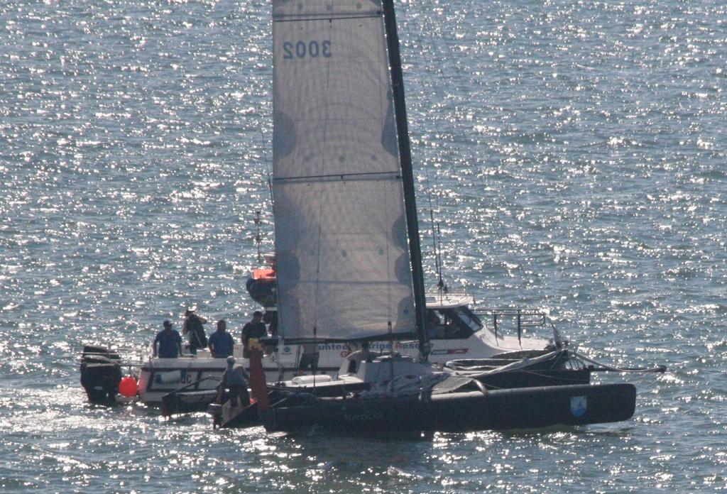 Morticia getting their case of beer - 50th Brisbane to Gladstone Multihull Yacht Race photo copyright Chris Dewar taken at  and featuring the  class