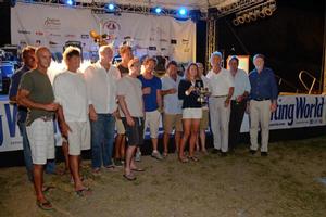 Mike Slade and crew of ICAP Leopard collect the Line Honours Trophy for the Yachting World Round Antigua Race photo copyright Ted Martin taken at  and featuring the  class