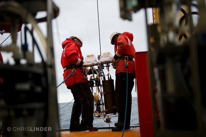 To measure particles at sea, marine geochemist Dan Ohnemus and colleagues literally vacuum them out of the water. They wrestle 150-pound, bellybutton-high, battery-operated pumps onto a wire and lower them down to various depths in the ocean © Chris Linder