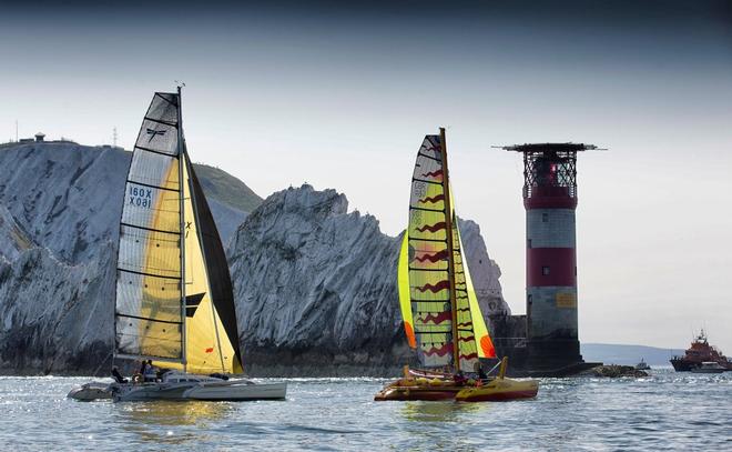 Wandering Glider battles rival boat as they meet the traitorous Isle of Wight landmark, The Needles. Navigating around their sharp and jagged rocks will be no easy feet. All eyes firmly on the JP Morgan Asset Management Round the Island Race 2014. © onEdition http://www.onEdition.com