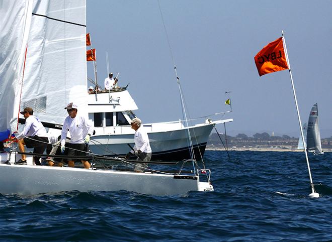 Dave Ullman and his J/70 crew cross finish line in first place © Rich Roberts