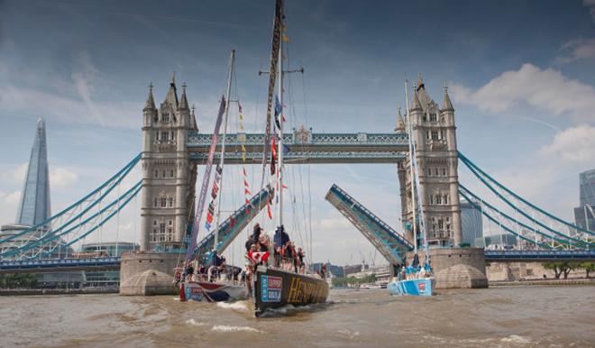 The Henri Lloyd leads the pack as the top three finishers pass under London's Tower Bridge at the Parade of Sails ending the 2013-2014 Clipper Round the World yacht race.  © EMPICS Sport