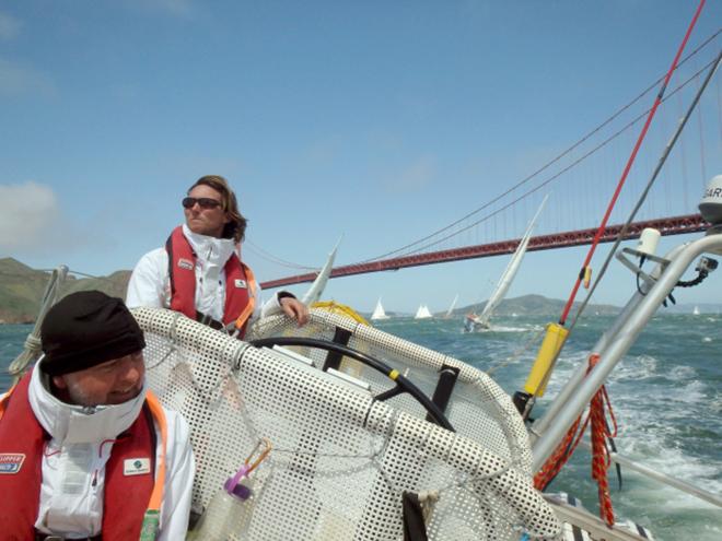 Henri Lloyd skipper Eric Holden guides his team's sailboat near the Golden Gate Bridge on April 19, 2014, for the start of Race 11, from San Francisco to Panama City, in the Clipper 2013-14 Round the World Yacht Race. © Clipper Ventures/Canadian Press